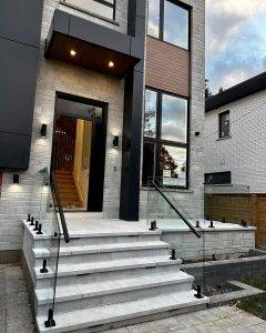 Modern Brick House Entrance and Glass Railing Stairs